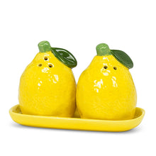Load image into Gallery viewer, Lemon &amp; Pepper Shakers, glossy yellow ceramic lemon-shaped salt and pepper shakers with light green stems and dark green leaves, displayed on a matching yellow ceramic oblong tray, against a white background. 