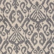 Load image into Gallery viewer, Ikat Throw, close-up of the cream cotton ikat throw with repeated gray ornamental motifs. 