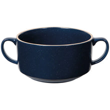Load image into Gallery viewer, Danica Soup Bowl, a navy blue stoneware soup bowl with a subtle reactive glaze and fine white speckles, featuring dual side handles, a tapered bottom portion, and a distinct flat light brown rim against a white background. 