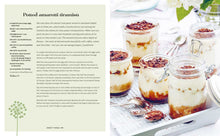 Load image into Gallery viewer, Picnic Cookbook, open cookbook displaying a recipe page alongside a photo of five individual tiramisu desserts    in glass jars with creamy layered filling, topped with chocolate shavings and cocoa powder, arranged on a white tray with silver spoons and scattered cocoa powder. 