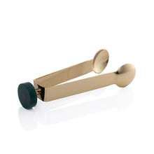 Load image into Gallery viewer, Gold finish metal tongs with a round dark green resin accent on the end displayed against a white background. 