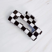 Load image into Gallery viewer, Checker Lovers Hair Claw Clip | 5 Styles, rectangular black and white checkerboard hair claw clip with a cutout center and interlocking teeth, displayed on a white background. 
