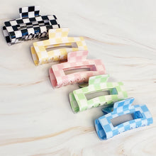Load image into Gallery viewer, Checker Lovers Hair Claw Clip | 5 Styles, five rectangular hair claw clips with open cutout centers, featuring white checkerboard patterns paired with black,  yellow, pale pink, pale green, and blue, displayed on a white marble surface. 