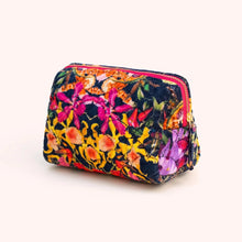 Load image into Gallery viewer, Botanical Kaleidoscope Quilted Vanity Bag, rectangular bag with a rounded corners, hot pink trim, a gold-tone zipper and a vibrant multicolored floral rainforest pattern with black background, displayed against a white background. 
