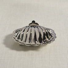 Load image into Gallery viewer, Polished nickel fan shell lidded bowl shown closed, highlighting the smooth scalloped design and reflective finish, displayed against a light background.
