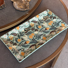 Load image into Gallery viewer, Autumn Acorn Platter, rectangular smooth dolomite platter with rounded corners, a slightly recessed center, and an acorn, floral, berry, and leafy pattern in shades of orange, brown, white, and gray-green on a pale blue-green background, displayed on a dark textured surface. 