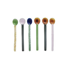 Load image into Gallery viewer, Set of six colorful two-toned glass spoons on a white background. Spoon colors include green with yellow and white stripes, white and hunter green, blue with green and white stripes, amber and green ,amber and hunter green, and amber and white. Spoons on a white background.