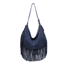 Load image into Gallery viewer, Midnight Reba Hobo, front view of a navy blue suede hobo bag with a curved top, rounded lower edge, central vertical seam, and long fringe along the sides and bottom, suspended from a matching adjustable shoulder strap against a white background.