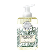 Load image into Gallery viewer, Evergreen Foaming Hand Wash, front view of a clear rectangular plastic bottle filled with pale yellow soap and topped with a white foaming pump, featuring a round silver-colored embossed seal above an illustrated forest of evergreen trees in shades of green on a white label with a cream “Michel Design Works Evergreen” panel, against a white background.