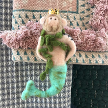 Load image into Gallery viewer, Felt Merman Ornament, wool felt merman ornament with a gold crown, light brown beard and hair, green seaweed boa, and aqua tail, displayed on patterned textiles.